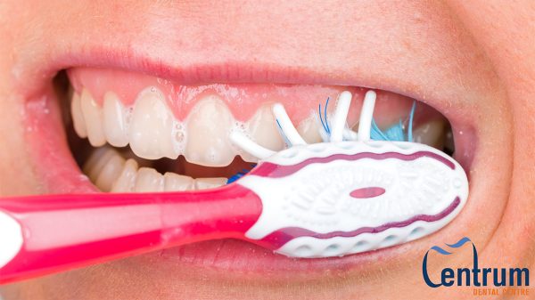 A person brushing their teeth.